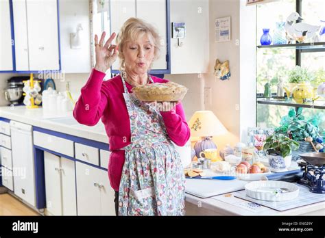 Older Caucasian Woman Baking Pie In Kitchen Stock Photo Alamy