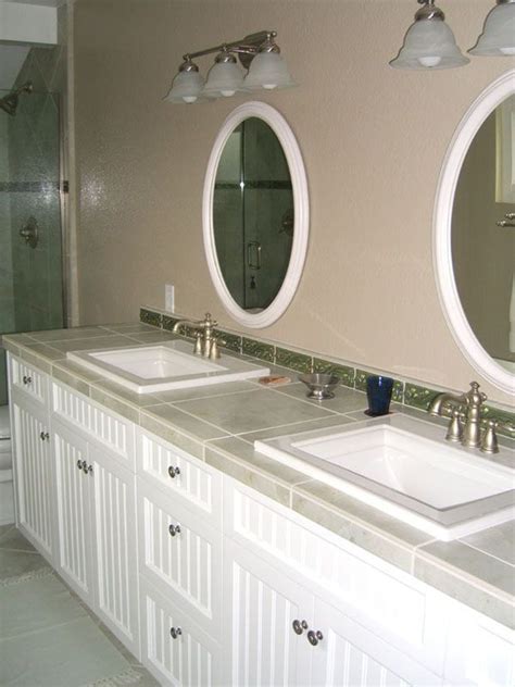 Bathroom countertops are a simple way to dress up the small space. Use extra floor tiles for a tile countertop in bathrooms ...