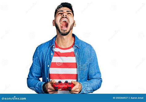 Young Hispanic Man With Beard Playing Video Game Holding Controller