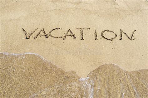 Word Vacation Is Written On A Sandy Surface Stock Image Image Of