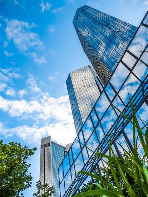 Modern Skyscrapers In Business District Against Blue Sky Stock Photo