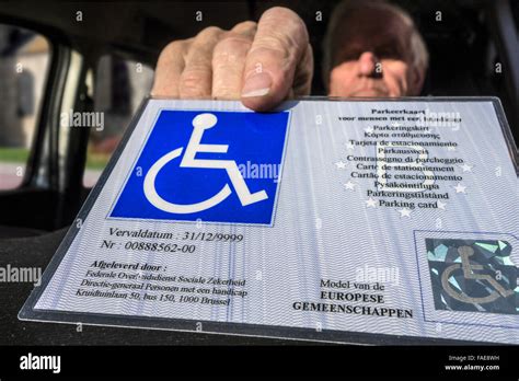 Handicapped Elderly Man Placing Eu Parking Card For People With