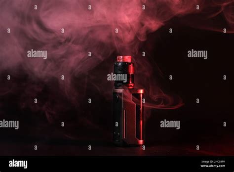 Electronic Vaping Device Mod Atomizer Stands In Vape Smoke And Vapor