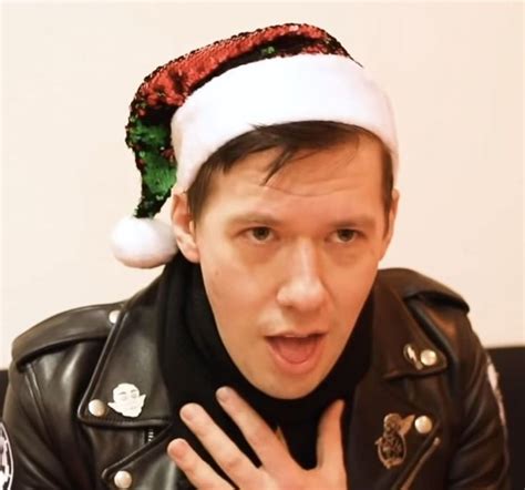 A Man Wearing A Santa Hat Making A Funny Face