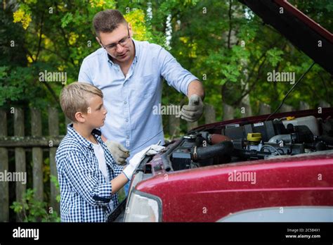 Father Teaching His Son How To Repair The Car Stock Photo Alamy