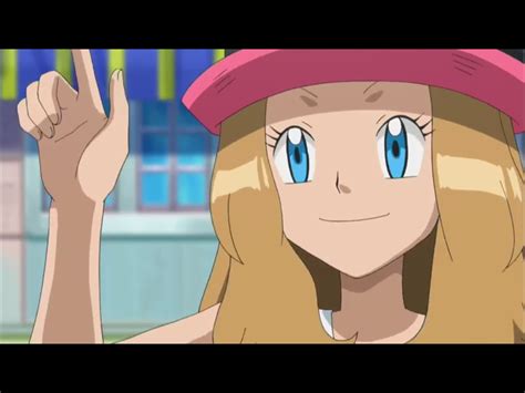 a woman with long blonde hair and blue eyes wearing a pink hat is making the peace sign