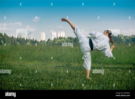 Teenage Girl Practicing Karate Kata Outdoors Performs The Uro Mawashi Geri Hook Kick Stock