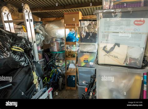 Plastic storage boxes filled with belongings and clutter in a garage