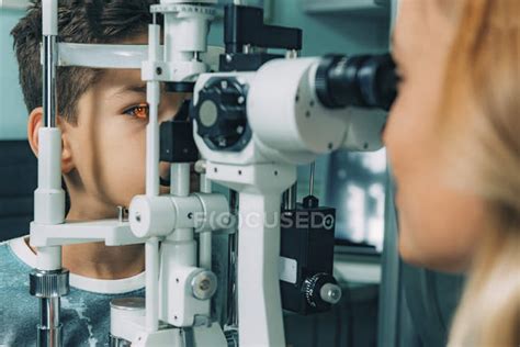 Ophthalmologist Examining Boy Eyes With Slit Lamp In Clinic