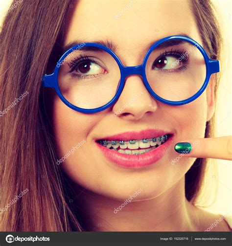 Nerdy Woman Showing Her Teeth With Braces Stock Photo By ©voyagerix