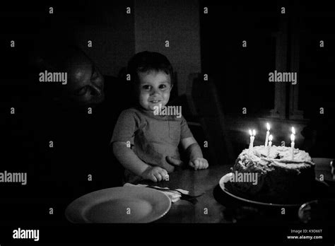 Toddler Boy Blowing Out Candles On His Birthday Cake Stock Photo Alamy