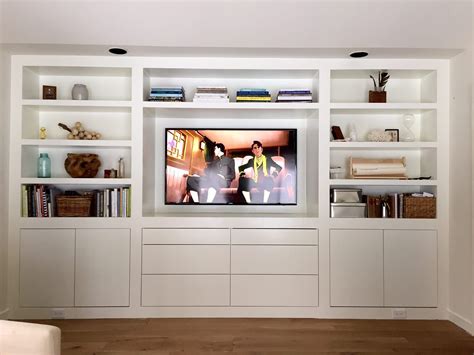 I used three in stock brown maple home depot upper kitchen cabinets (30 wide x 18 high x 12 deep), plywood, bead board, 1x2 & 1x3 boards and some decorative moulding! The Room of Requirement Built-ins | Built in tv cabinet ...