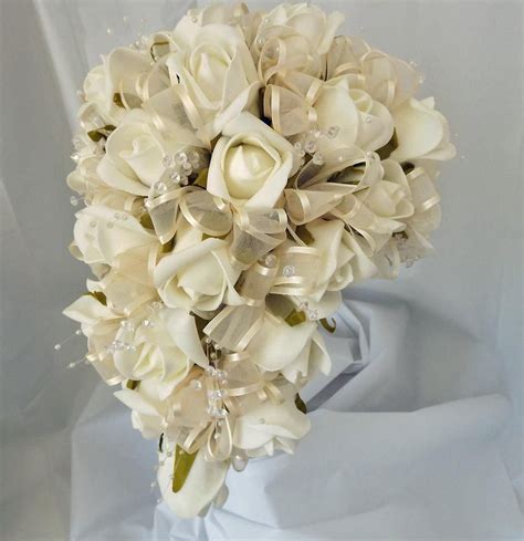 An Artificial Shower Bouquet Featuring Ivory Foam Roses Crystals And