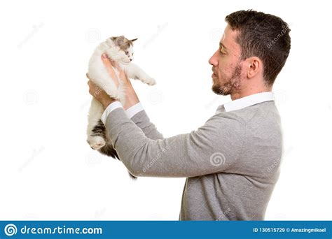 Profile View Of Young Handsome Caucasian Man Holding Cat Stock Image