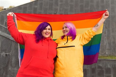 Premium Photo Happy Young Women Lesbian Holding Lgbtq Pride Flag