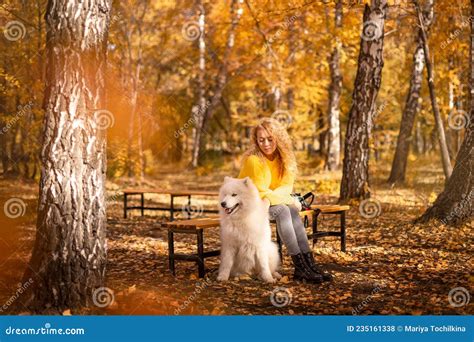 Cheerful Redhead Girl Is Playing In The Park In Autumn With Her Big