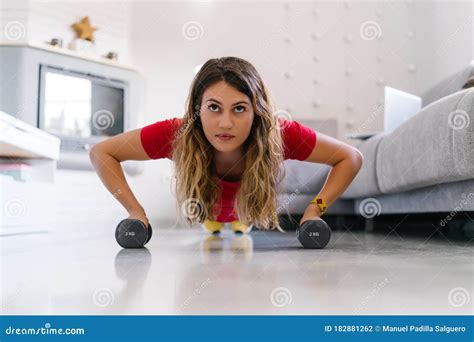 Woman Doing Push Ups With Dumbbells At Home Stock Photo Image Of