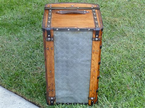 An Old Fashioned Suitcase Sitting In The Grass