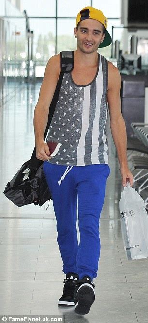 The Wanteds Jay Mcguiness Arrives At The Airport Holding A Large Stuffed Frog Daily Mail Online