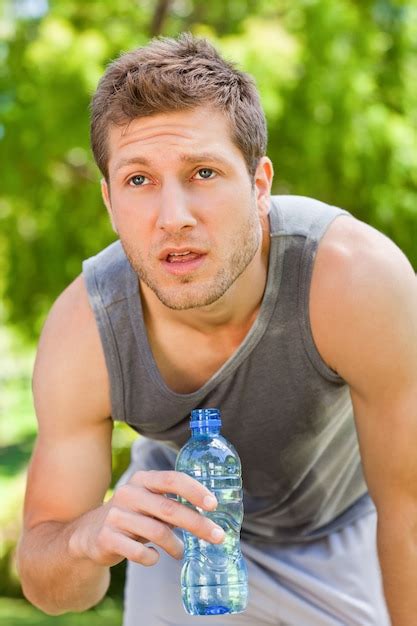 Premium Photo Sporty Man Drinking Water In The Park