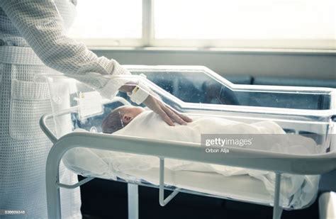 Newborn Baby Boy Asleep In Hospital Bassinet High Res Stock Photo