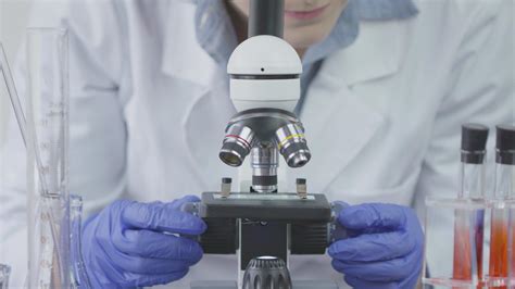 Scientist Using Microscope - FILMPAC