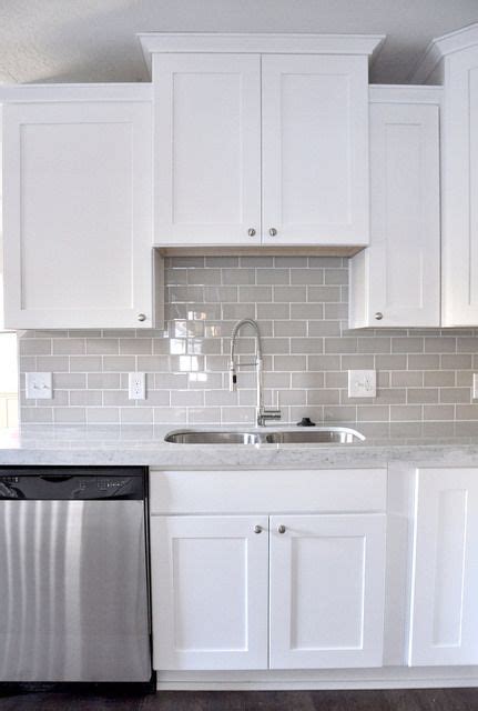 The transitional kitchen's masterpiece is the gorgeous hood with a great island! Gray subway tile and white cabinets | Ikea Decora