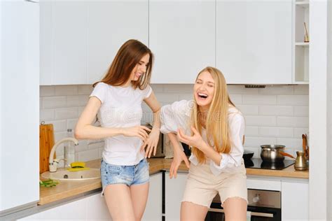 Two Women Laughing In The Kitchen Stock Image Image Of Beautiful