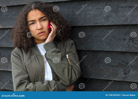 Sad Mixed Race African American Teenager Woman Using Cell Phone Stock
