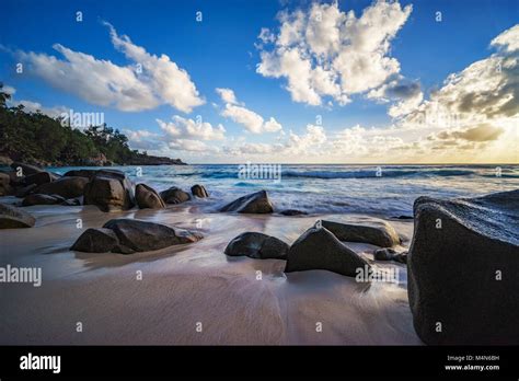 Beautiful Sunset At Paradise Tropical Beach With Granite Rocks Sand
