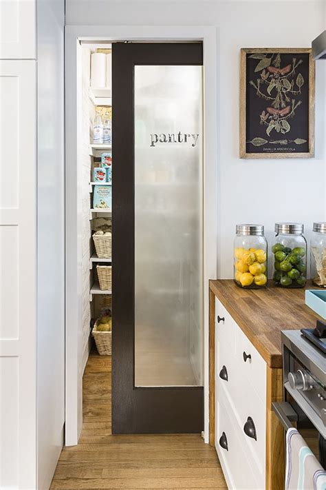Some shelving can be slipped straight into the closet and loaded with goods, or you can create your own internal organizer. Frosted glass door of pantry in white kitchen | Glass ...