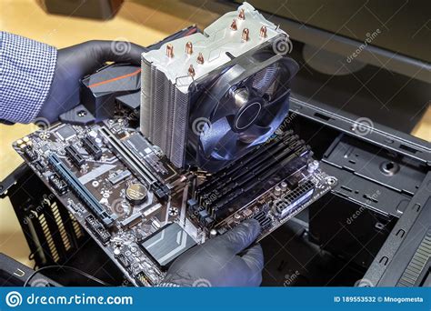 Assembling Desktop Computer Serviceman Installs Motherboard In