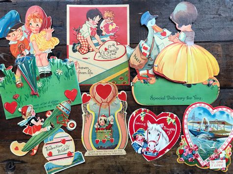 Several Vintage Valentines Day Greetings Are Displayed On A Wooden