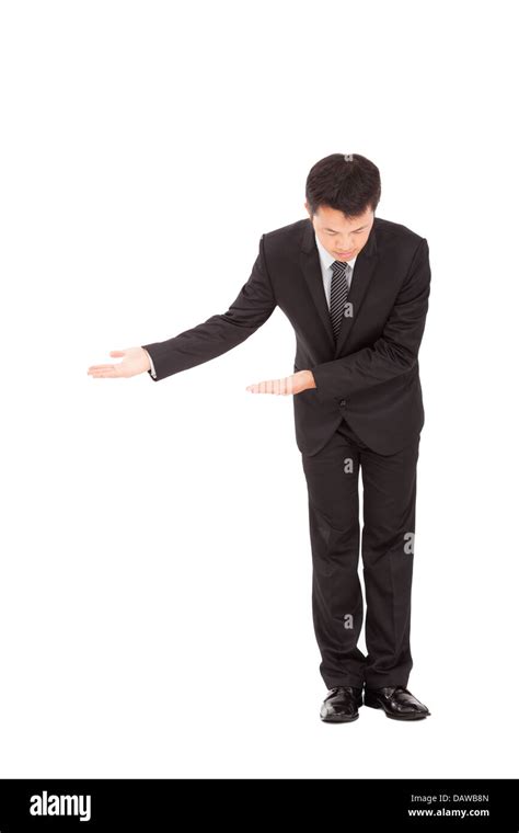 Full Length Of Asian Businessman With Bow And Welcome Gesture Stock