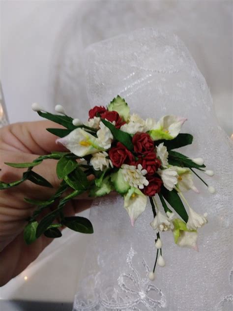 A Person Holding A Bouquet Of Flowers In Their Left Hand And Wearing A Wedding Ring