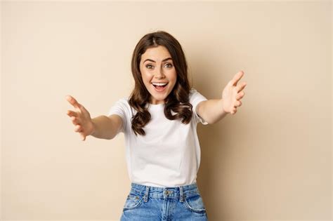 Free Photo Portrait Of Happy Young Woman Smiling Stretching Arms Out