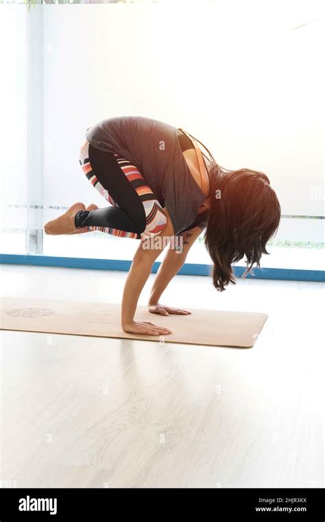 Attractive Sporty Woman Practising Yoga Standing In Crane Exercise Bakasana Pose Working Out
