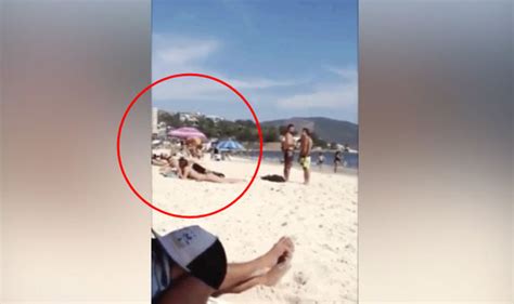 Video Captures Sunbathing Girl Getting Huge Shock When Beachgoer Does