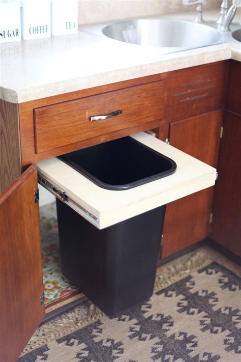 Perhaps dual trash cans, with a garbage can and a recylce bin or a small trash can for just your food scraps, or a motion sensor trash can is ideal. Convert a Cabinet into a Pull-Out Trash Bin | A Beautiful ...