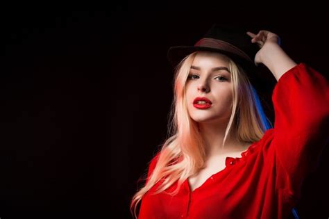 Premium Photo Stylish Blonde Woman In Red Blouse And Brown Hat Posing