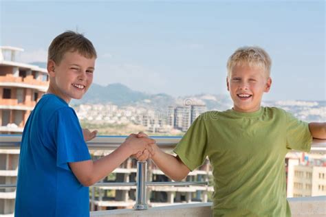 Two Smiling Boys In T Shirts Are Shake Hands Stock Photo Image Of