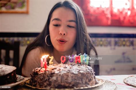 Girl Blowing Out Candles On A Birthday Cake Photo Getty Images