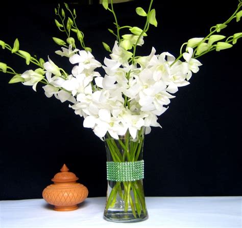 A Vase Filled With White Flowers On Top Of A Table