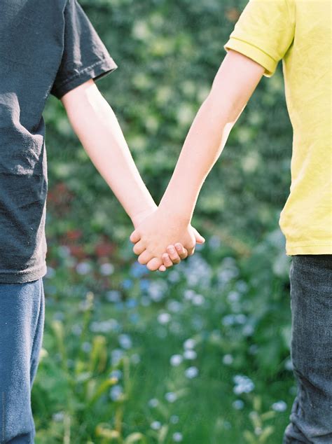 Mid Section Of Two Boys Holding Hands By Stocksy Contributor Kirstin
