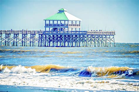 Folly Beach Fishing Pier And Waves Crashing Into Land On Sunny D