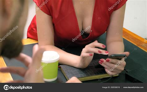 Office Flirt Attractive Woman In Red Overalls With A Deep Neckline Flirting At The Table With