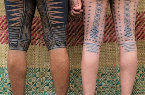 Two People Standing Next To Each Other With Tattoos On Their Arms And