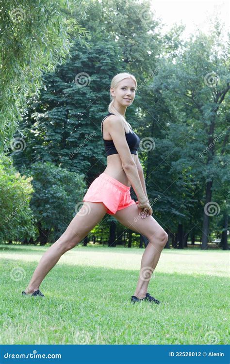 The Beautiful Blonde Stretching Outdoors Stock Photo Image Of Grass