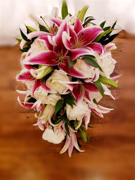 cascading pink tiger lilies and rose s wedding bouquet tiger lily wedding flowers outdoor
