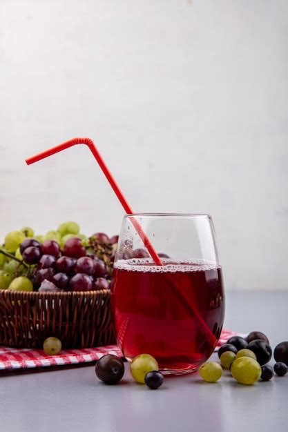 Free Photo Side View Of Black Grape Juice In Glass With Grapes In